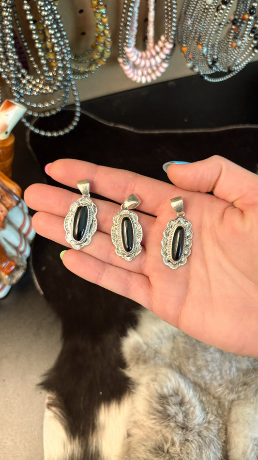 OVAL BLACK ONYX PENDANT WITH STAMPED BORDER BY PEGGY SKEETS