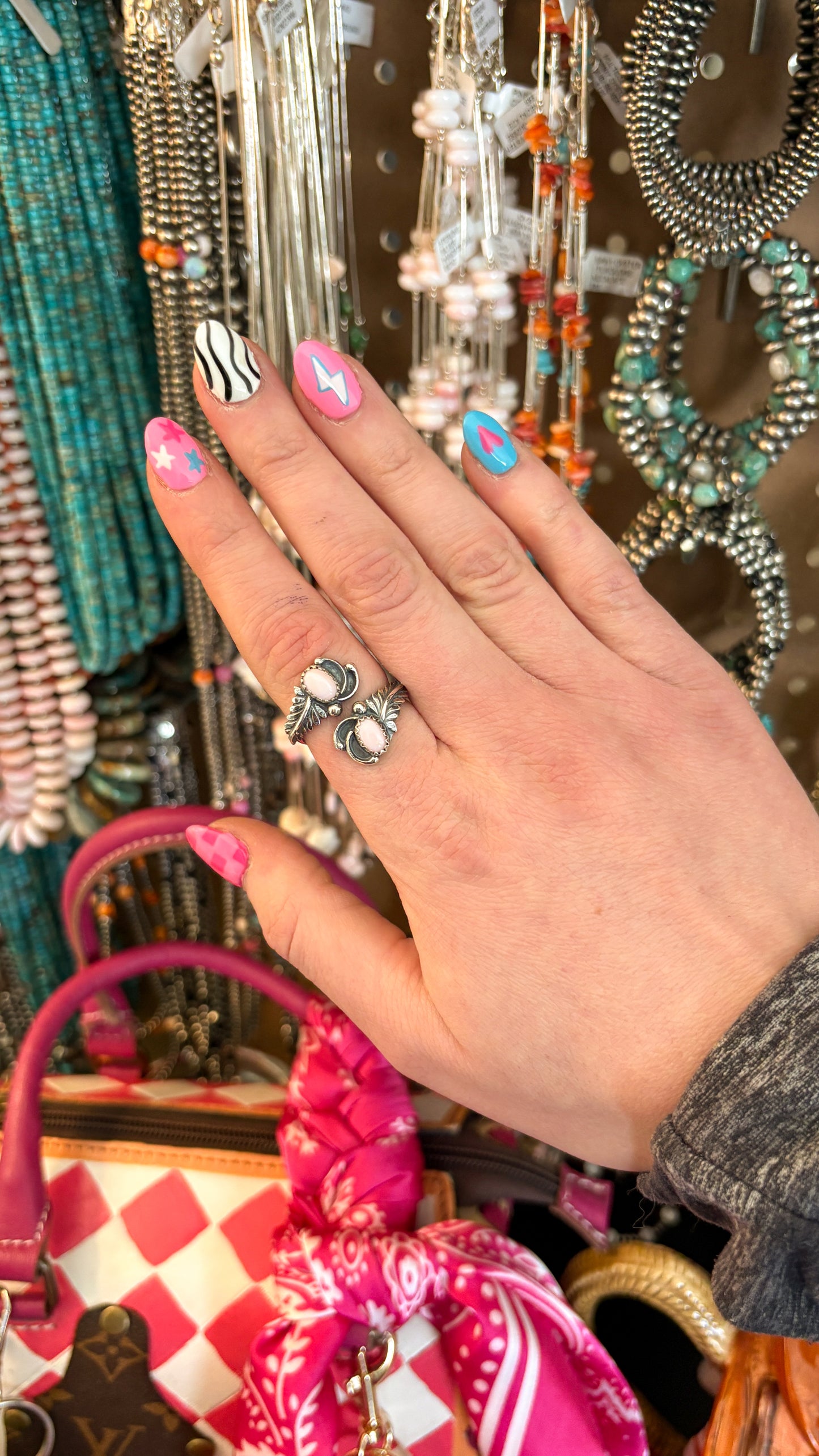 PINK CONCH ADJUSTABLE FEATHER RING BY ETTA BELIN